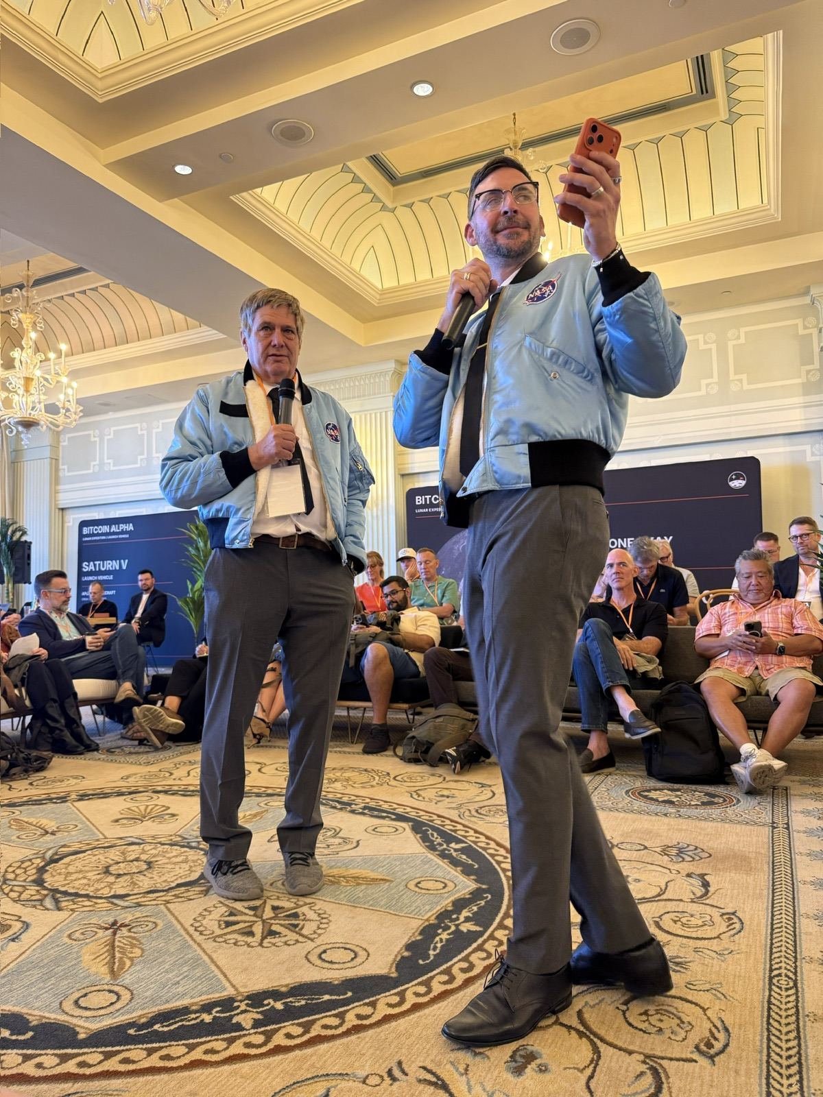 The hosts on stage in flight jackets